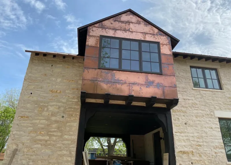 Copper metal panel facade on a stone building for Skylight Installation in Greeley