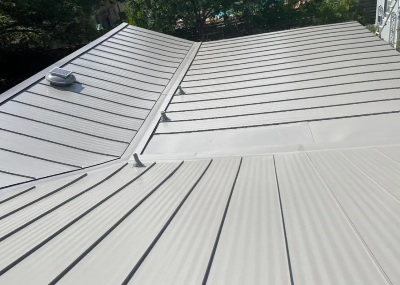 Solar attic fan installed on a metal roof for Roof Ventilation in Greeley